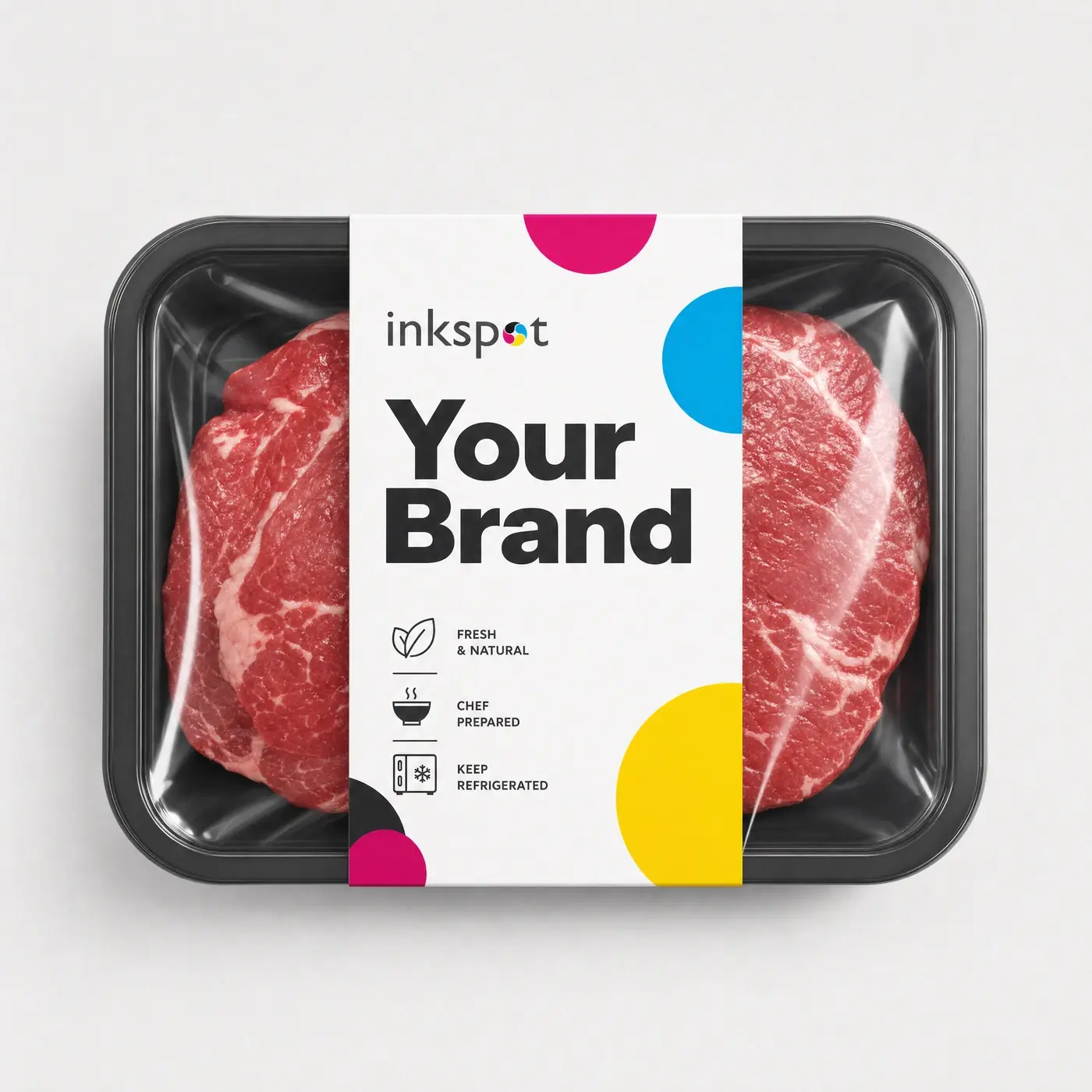 A chilled meat tray with a printed board sleeve banded around it, shot from above.