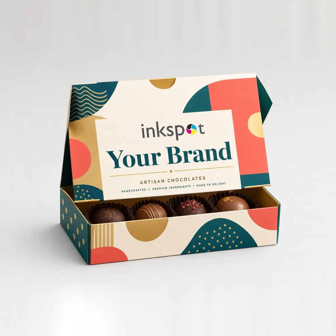 An open hinged-lid box of artisan chocolates, printed in flat colour shapes.