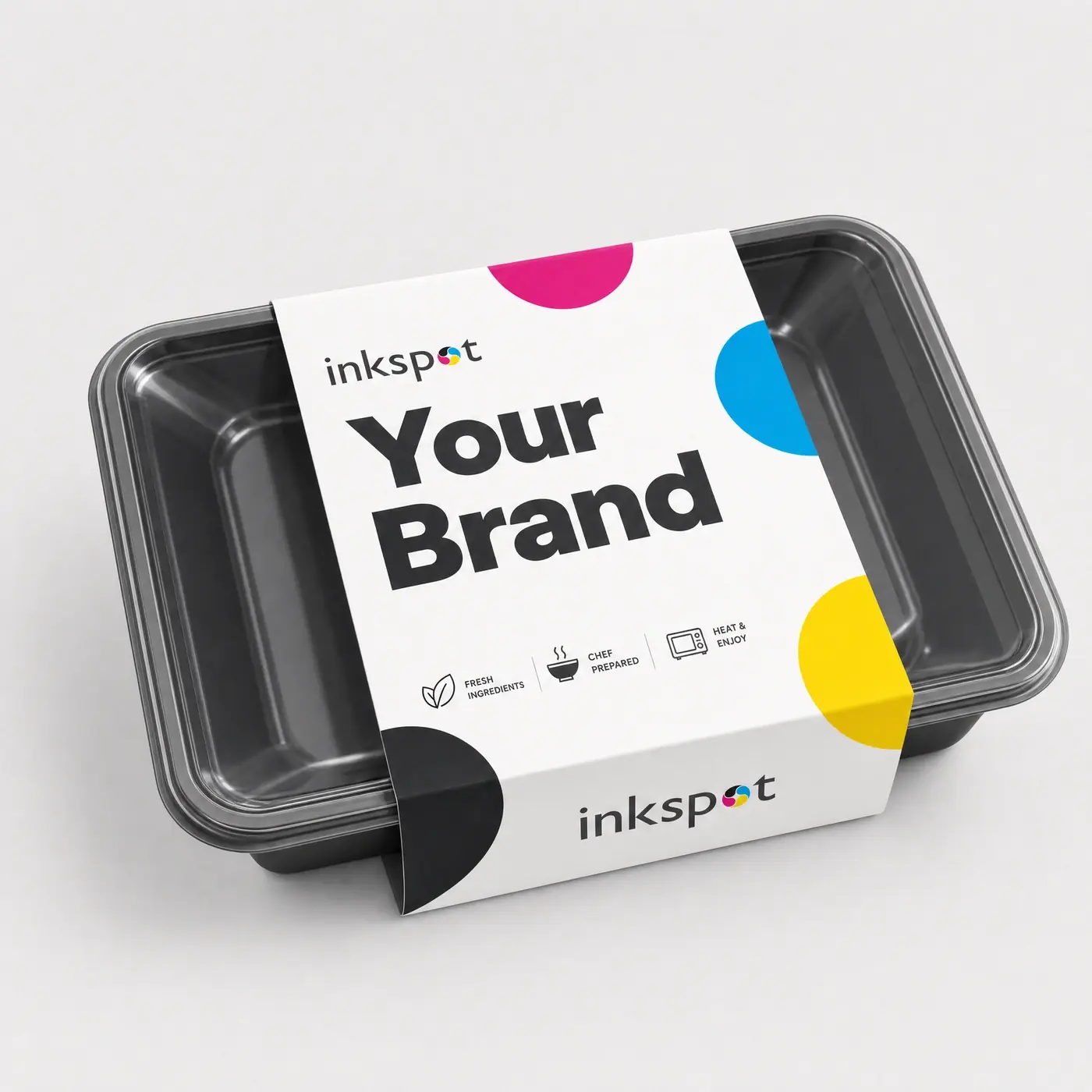 A black ready-meal tray with a printed board sleeve wrapped around it.