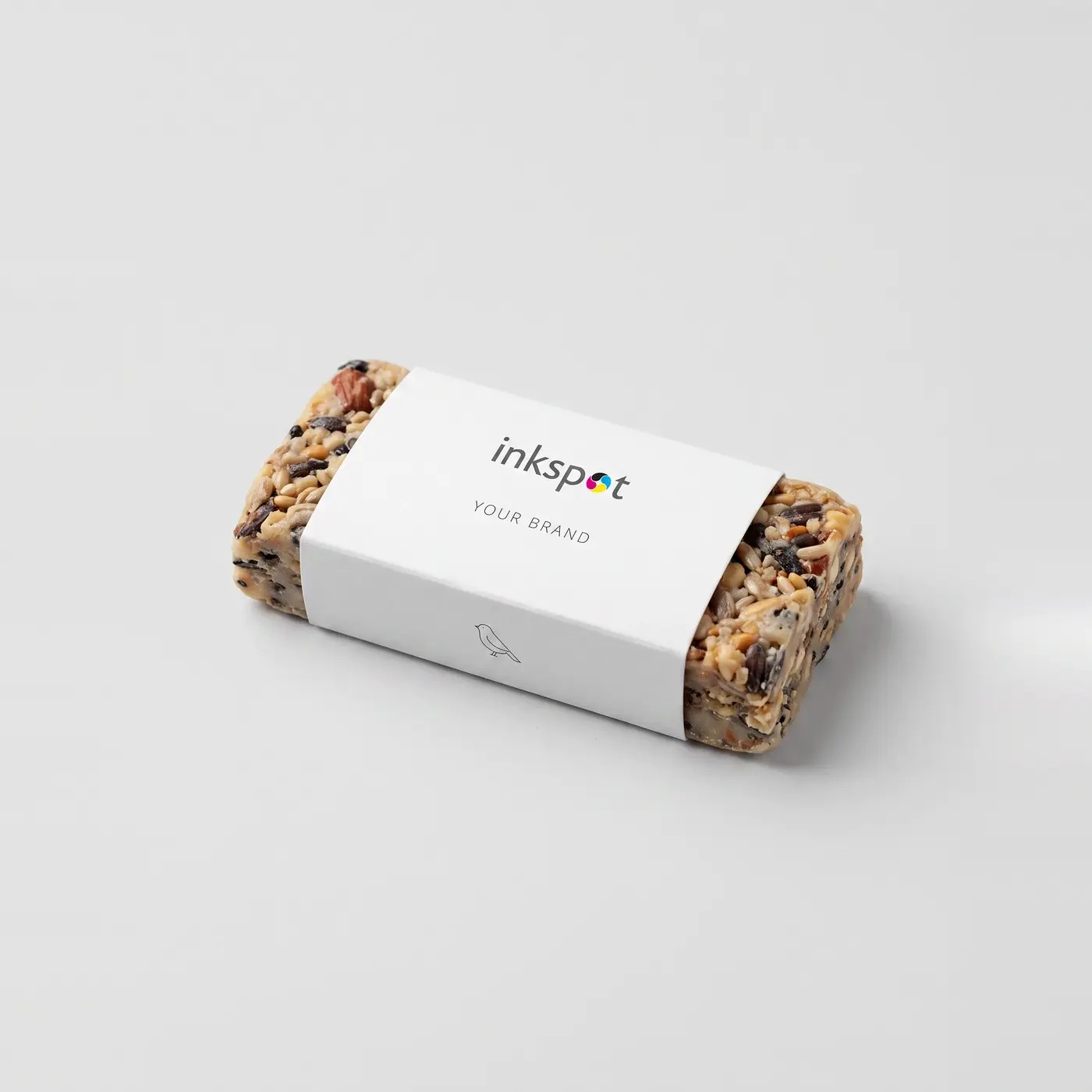 A pressed birdseed block held by a printed paper band.