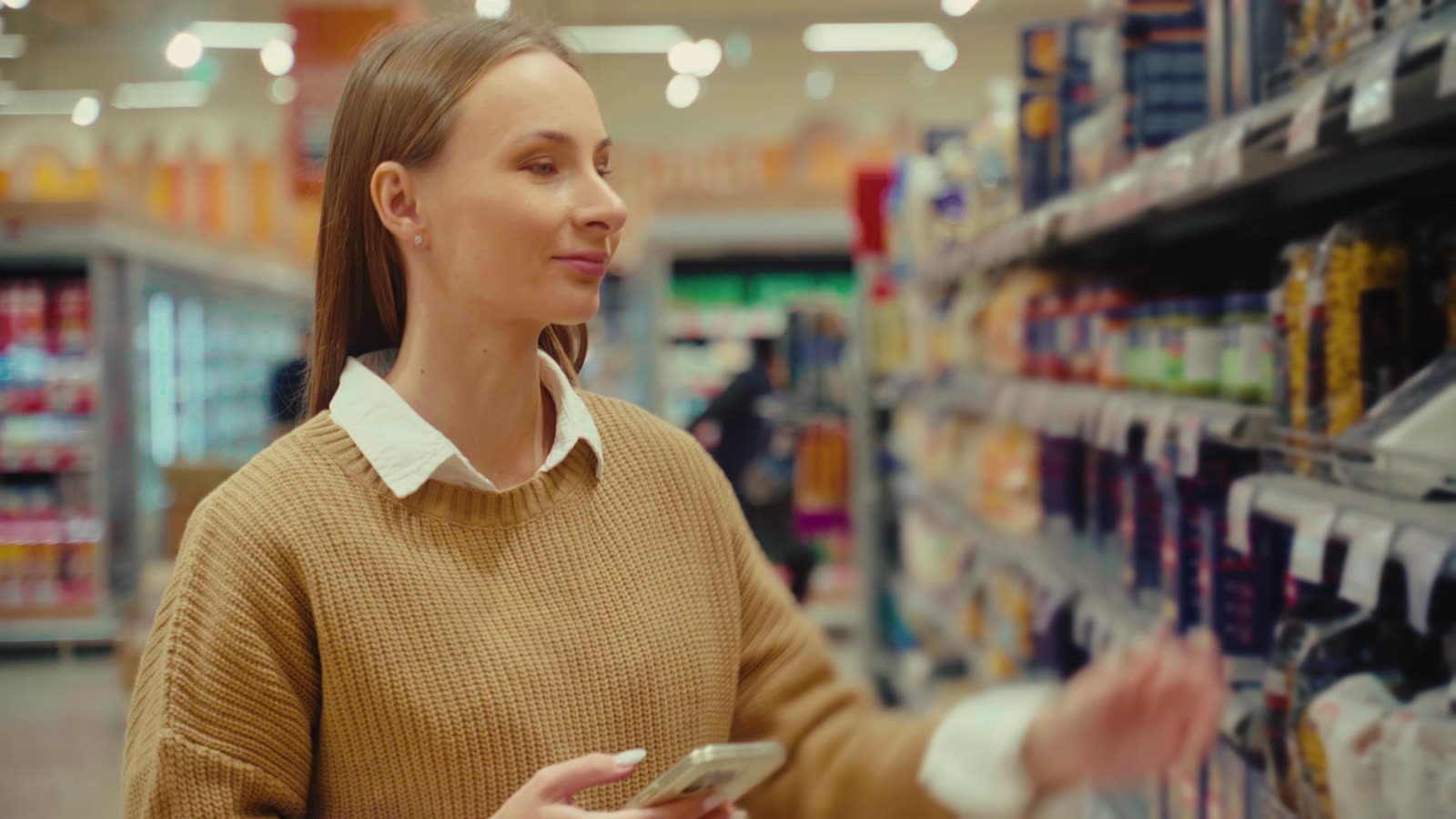 Printed cartons and sleeves lined up on a retail shelf under store lighting.